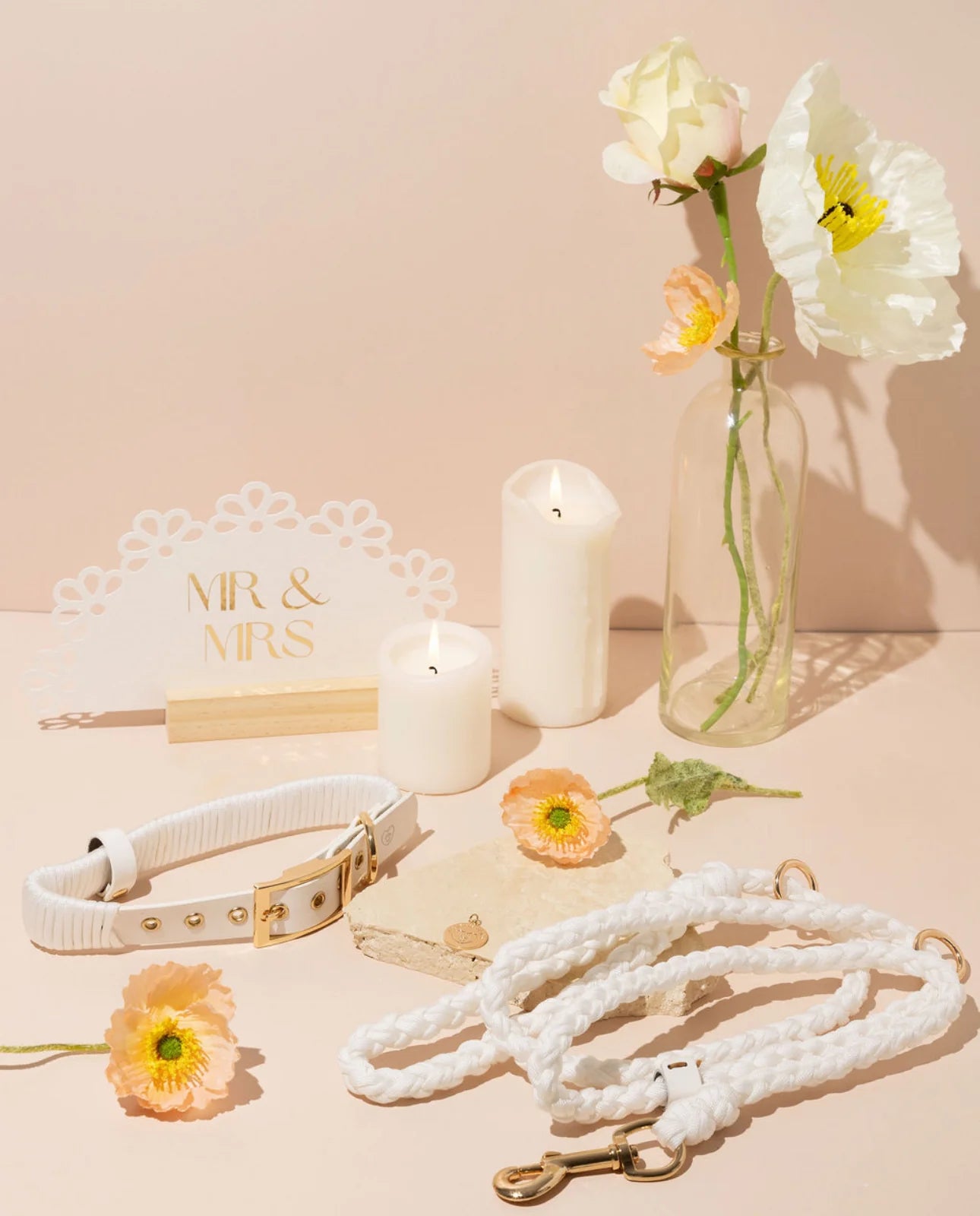 Pearl white Luxe Paracord and Vegan Leather pet leash set displayed with gold hardware and elegant candles. Features high-tensile paracord and butter-soft leather for a minimalist, high-end look
