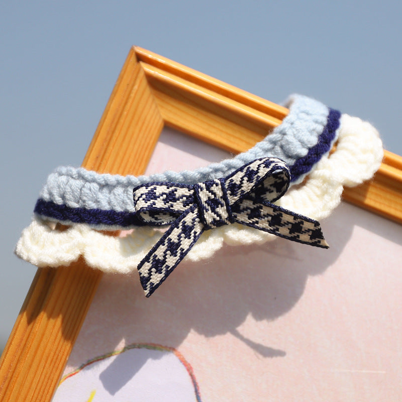 Styled shot of the navy blue knit collar on a wooden frame. An ideal gift for pets needing a sensory-friendly style upgrade