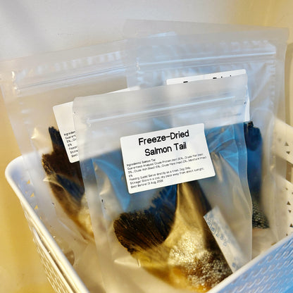 Bulk bags of salmon tail chews in a basket, perfect as a crunchy ASMR treat and natural beauty supplement for dogs.