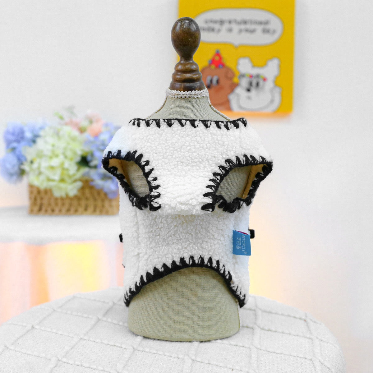 Back view of the Sherpa vest on a mannequin. The premium bouclé fabric mimics a warm hug, making it the perfect statement piece for cold weather fashionistas