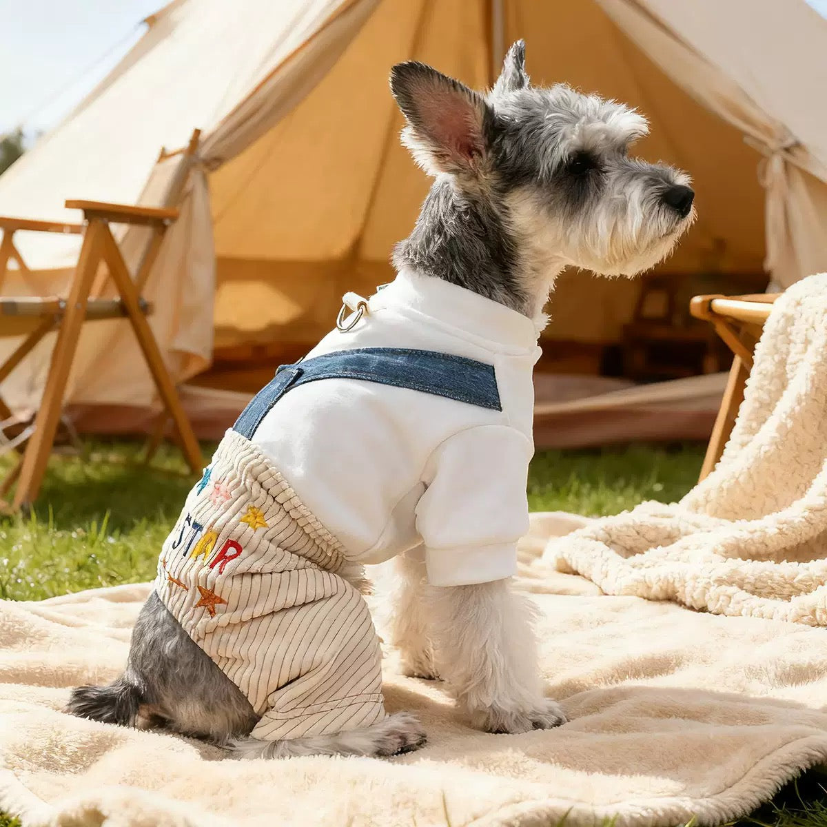 Side profile of a dog in the cream and beige fleece romper. The fake layered look combines a white fleece top with corduroy overalls for maximum warmth without bulk."