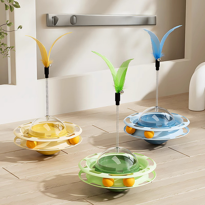 Three wobble toys in motion. The erratic movement mimics prey to trigger pouncing reflexes in cats.