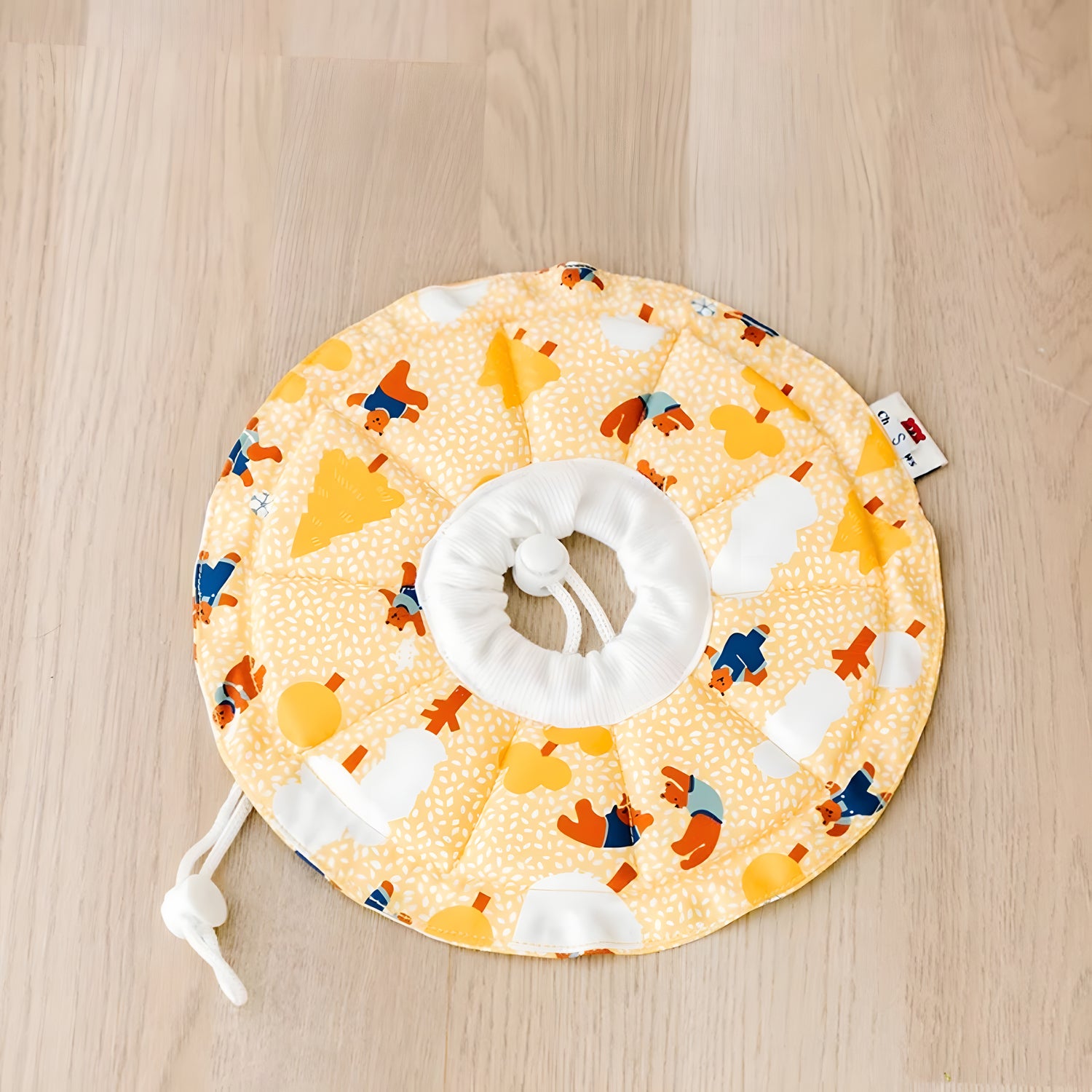 Yellow soft Elizabeth collar featuring a bear and tree pattern. The waterproof fabric prevents wet food messes during mealtime