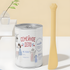 A butter yellow silicone spatula standing vertically next to a large, deep pet food can. The long ergonomic handle is perfect for reaching the bottom of dog and cat food tins.