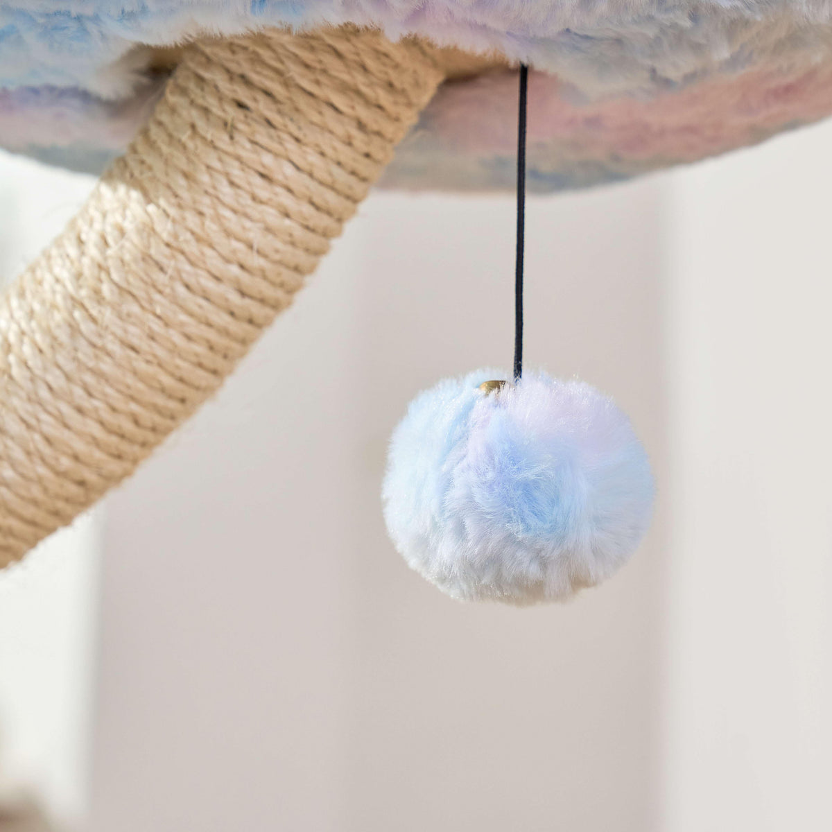 Pastel hanging pom-pom cat toy beneath an Aurora flower perch and sisal branch