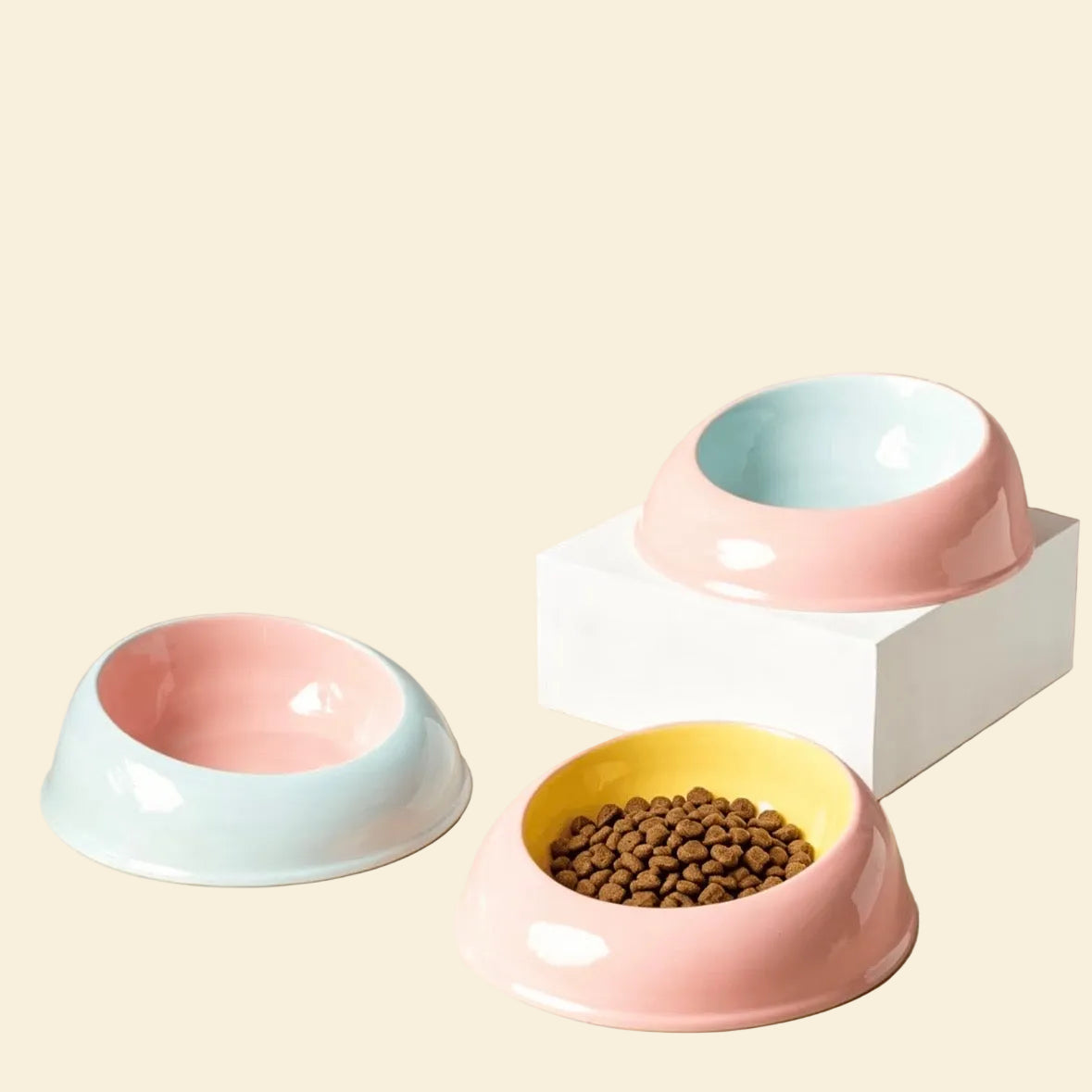Three Milk Candy ceramic cat bowls in glossy pastel two-tone colors: Strawberry Pink, Butter Yellow, and Powder Blue, elegantly displayed on a minimalist background.