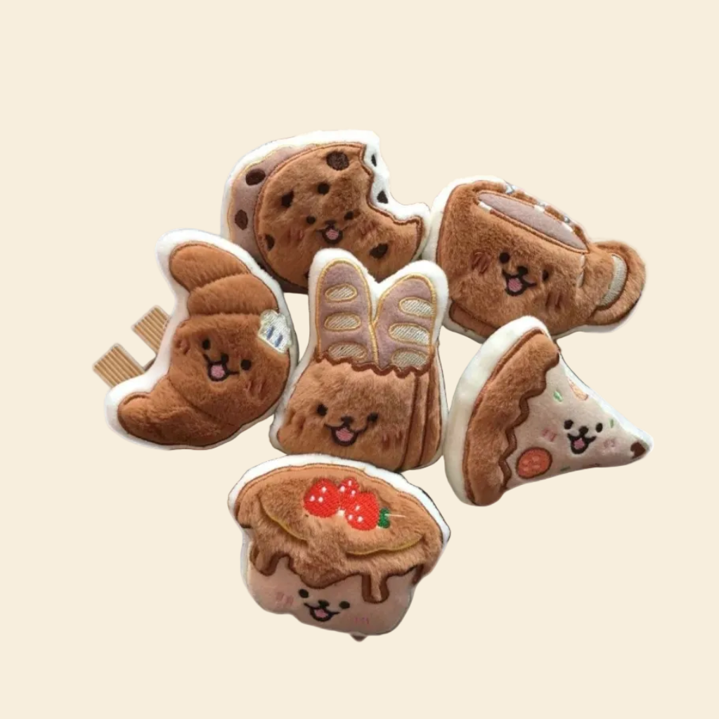 A stack of petite plush pastry toys on a yellow background, highlighting their small size and soft brown tones for small pets.