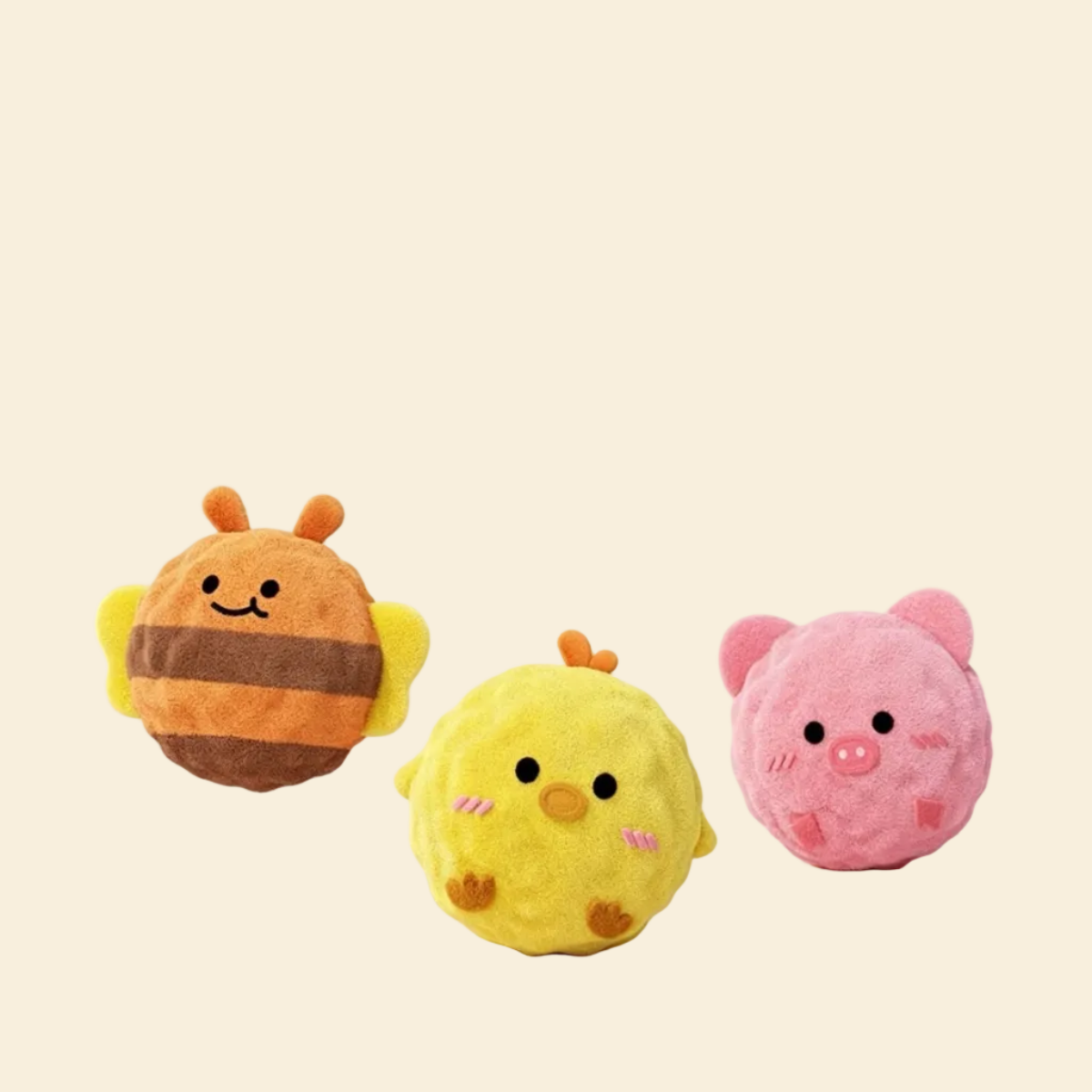 The complete Bouncy Buddies collection floating against a white background, featuring the Striped Bee, Yellow Chick, and Pink Piglet mini plush squeaky balls.