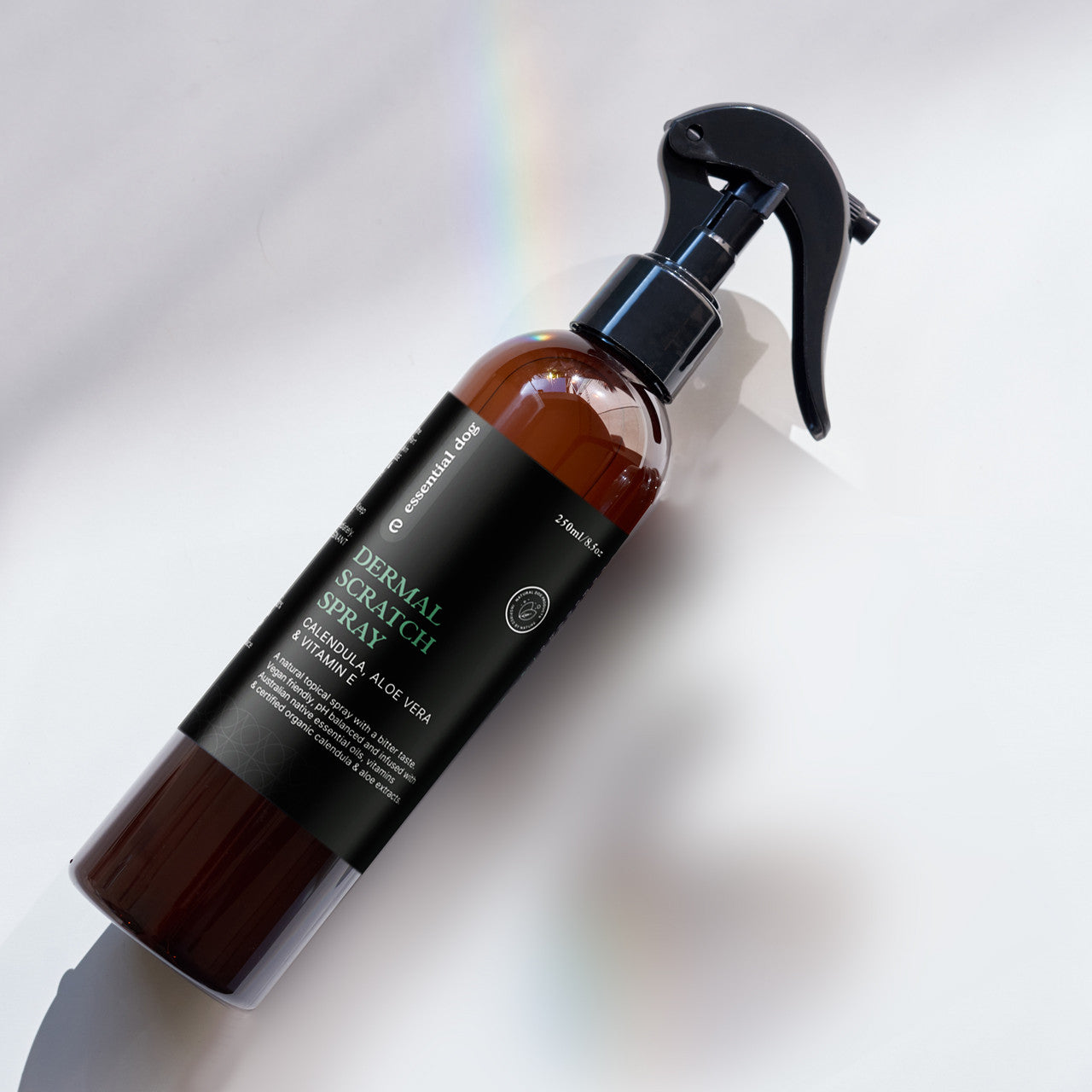 Essential Dog scratch spray basking in sunlight. The amber bottle protects the naturopath-formulated blend of essential oils and plant extracts from UV degradation