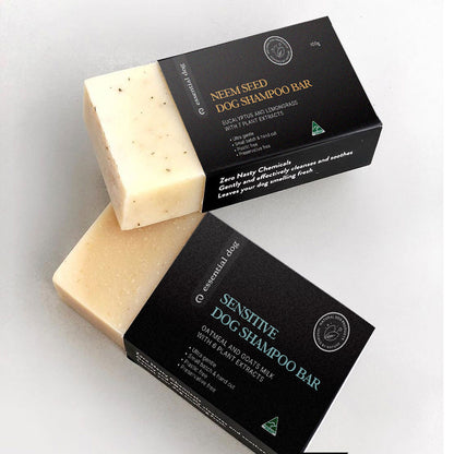 Two Essential Dog solid shampoo bars (Neem Seed and Sensitive Oatmeal) stacked together. Shows the rich, creamy texture handcrafted from coconut, olive, and shea butter