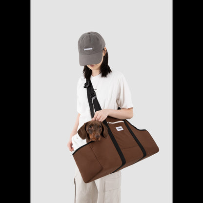 Model wearing the LéJoyee Nutshell Brown Sausage Dog Carrier Tote in a comfortable crossbody style, showcasing the structured design for long-bodied pets.