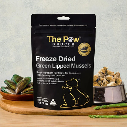 Product showcase of The Paw Grocer Green Lipped Mussels on a wooden board. Features a bowl of dried mussels as a meal topper for senior dogs and cats to boost mobility and reduce inflammation.