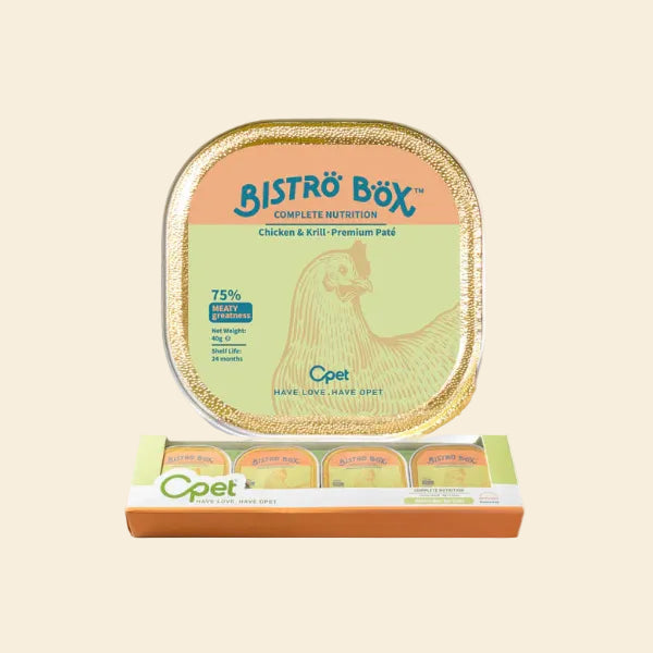 A top-down view of a single OPET Bistro Box Chicken &amp; Krill tray placed above its multipack retail display box, showing how the individual peel-and-serve trays are neatly packaged.