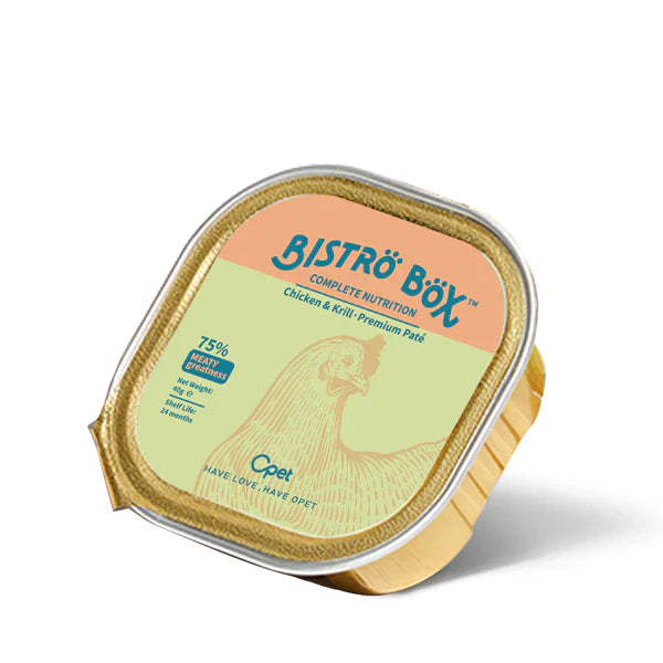 An angled view of a single 40g gold foil tray of OPET Bistro Box Wet Cat Food. The green and peach label features a chicken illustration and highlights "75% Meaty Greatness."
