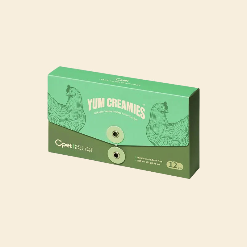 A green 12-count box of OPET Yum Creamies Lickable Creamy for Cats, featuring a detailed illustration of a chicken, highlighting the grain-free and high-protein chicken recipe
