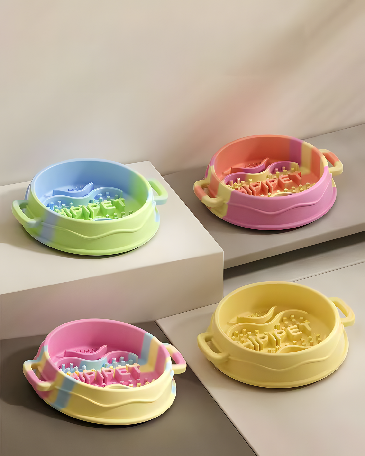 A beautifully arranged display of four silicone slow feeder bowls in different pastel swirl colors, showcasing the dopamine-boosting aesthetics for modern homes.