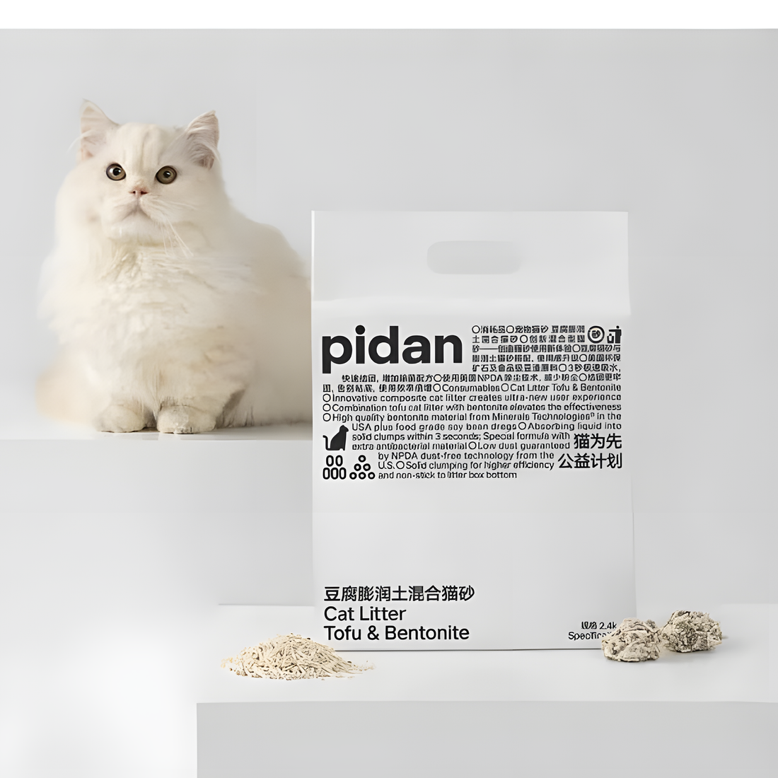 A white long-haired cat next to a bag of Pidan Composite Cat Litter. The 70/30 blend offers the safety of food-grade tofu and the clumping power of bentonite clay.