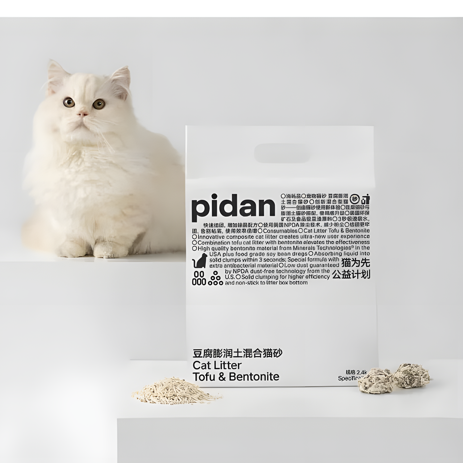 A white long-haired cat next to a bag of Pidan Composite Cat Litter. The 70/30 blend offers the safety of food-grade tofu and the clumping power of bentonite clay.