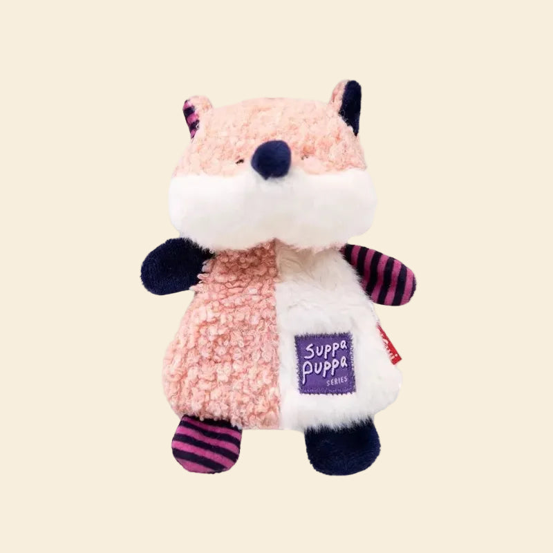 A clean studio shot of the plush fox dog toy against a yellow background, showcasing the adorable pink and navy blue color-blocked design and ultra-soft fleece material.