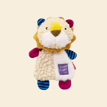 A clean studio shot of the plush lion dog toy against a yellow background, detailing its colorful color-blocked fleece body, crinkle paper lining, and woven brand tag.