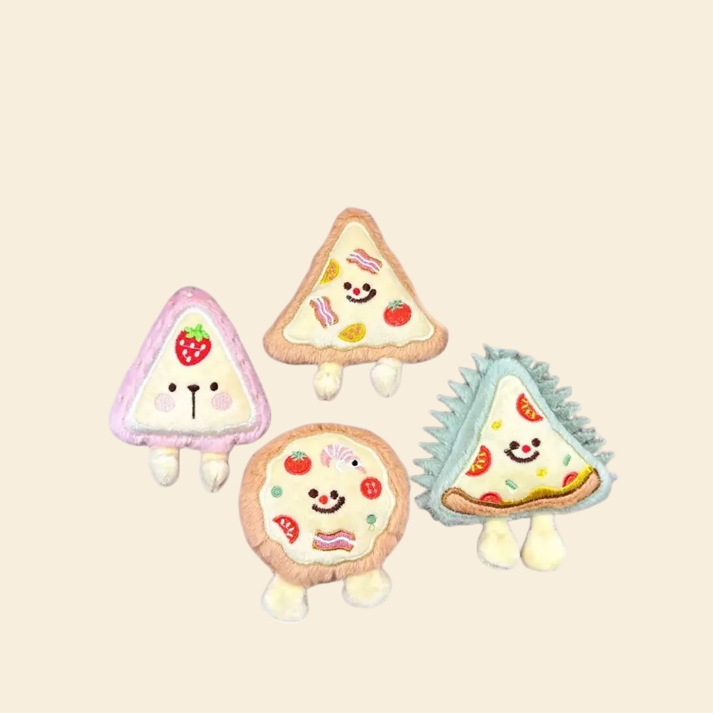 A group of four plush pet toys: a pink strawberry, a green durian slice, a triangular pizza, and a round pizza, all featuring cute embroidered faces and small stuffed feet.