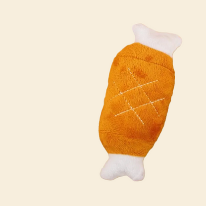 A full view of the Plush Giant Chicken Leg toy with its white bone handle, resting on a yellow background.