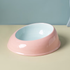 The ultra-glossy Milk Candy ceramic cat feeding dish with a powder blue exterior and soft pink interior, resting on a clean pastel surface.