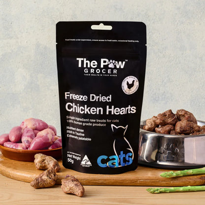 The Paw Grocer Chicken Breast cat and dog treats displayed on a wooden board with a piece of fresh raw chicken breast to show its single-ingredient quality.