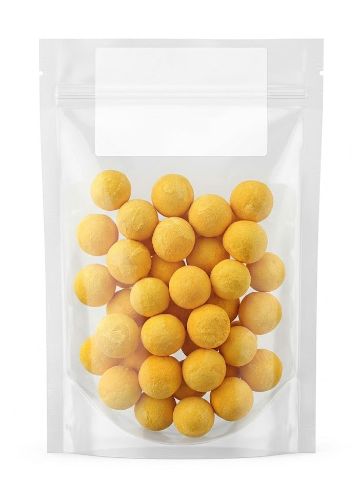 A clean studio shot of a clear stand-up pouch filled with golden freeze-dried quail egg yolk treats, highlighting their natural round shape and pure texture, perfect as a meal enhancer for cats and dogs.