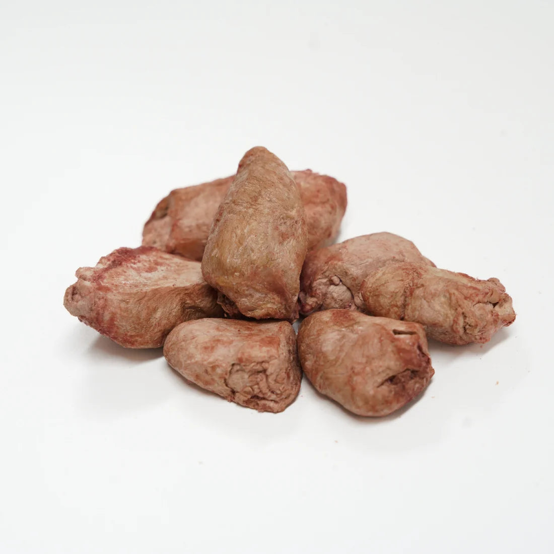 A close-up pile of RAFA raw freeze-dried Australian chicken hearts on a white background, highlighting the bite-sized, whole-prey texture rich in natural taurine.
