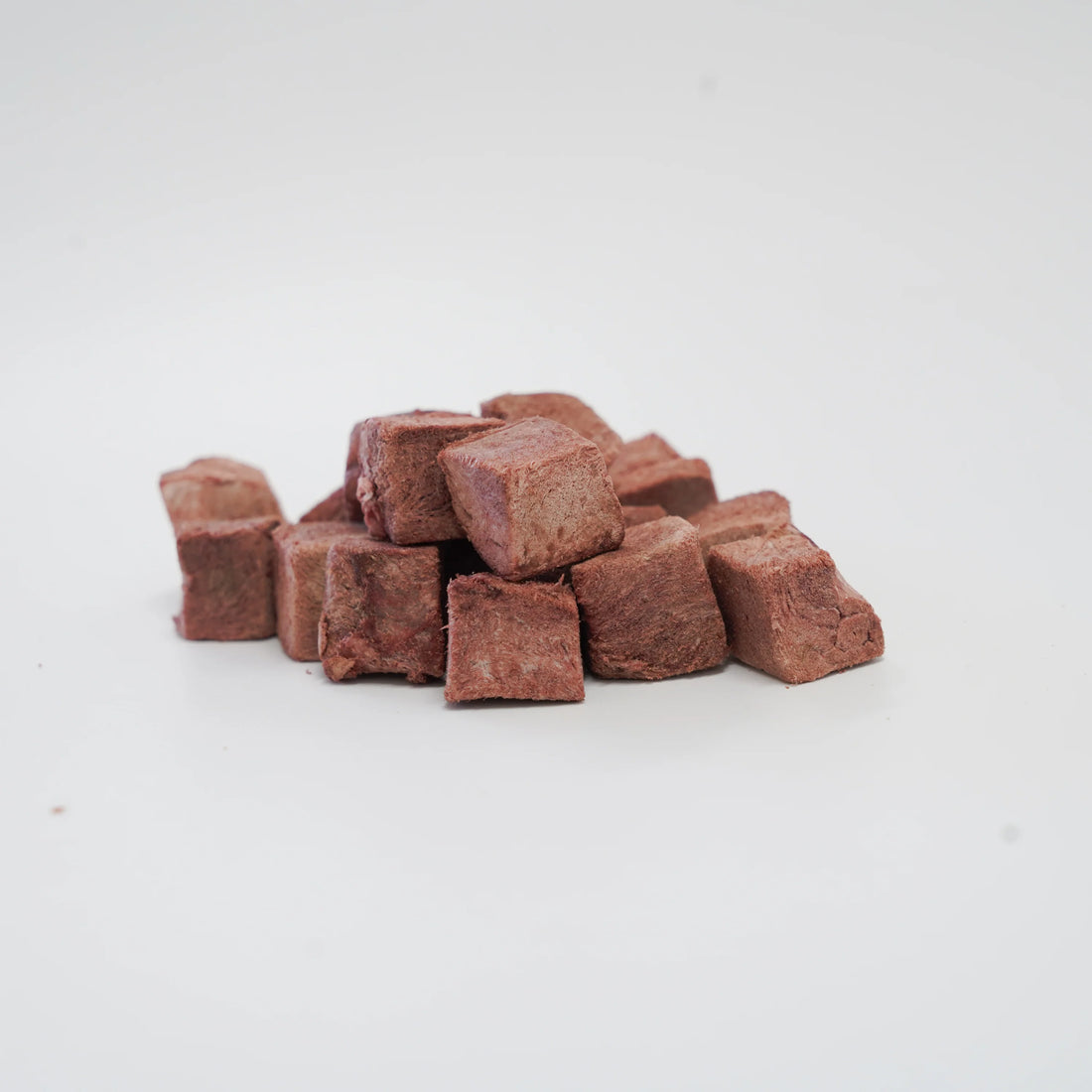 A close-up of RAFA raw freeze-dried Australian emu heart cubes on a white background, highlighting the pure, dense texture of this highly digestible, hypoallergenic novel protein.