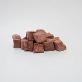 A close-up of RAFA raw freeze-dried Australian emu heart cubes on a white background, highlighting the pure, dense texture of this highly digestible, hypoallergenic novel protein.