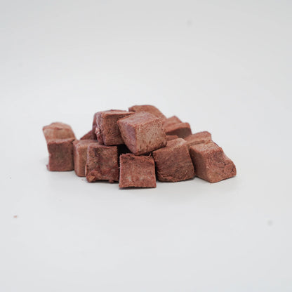A close-up of RAFA raw freeze-dried Australian emu heart cubes on a white background, highlighting the pure, dense texture of this highly digestible, hypoallergenic novel protein.