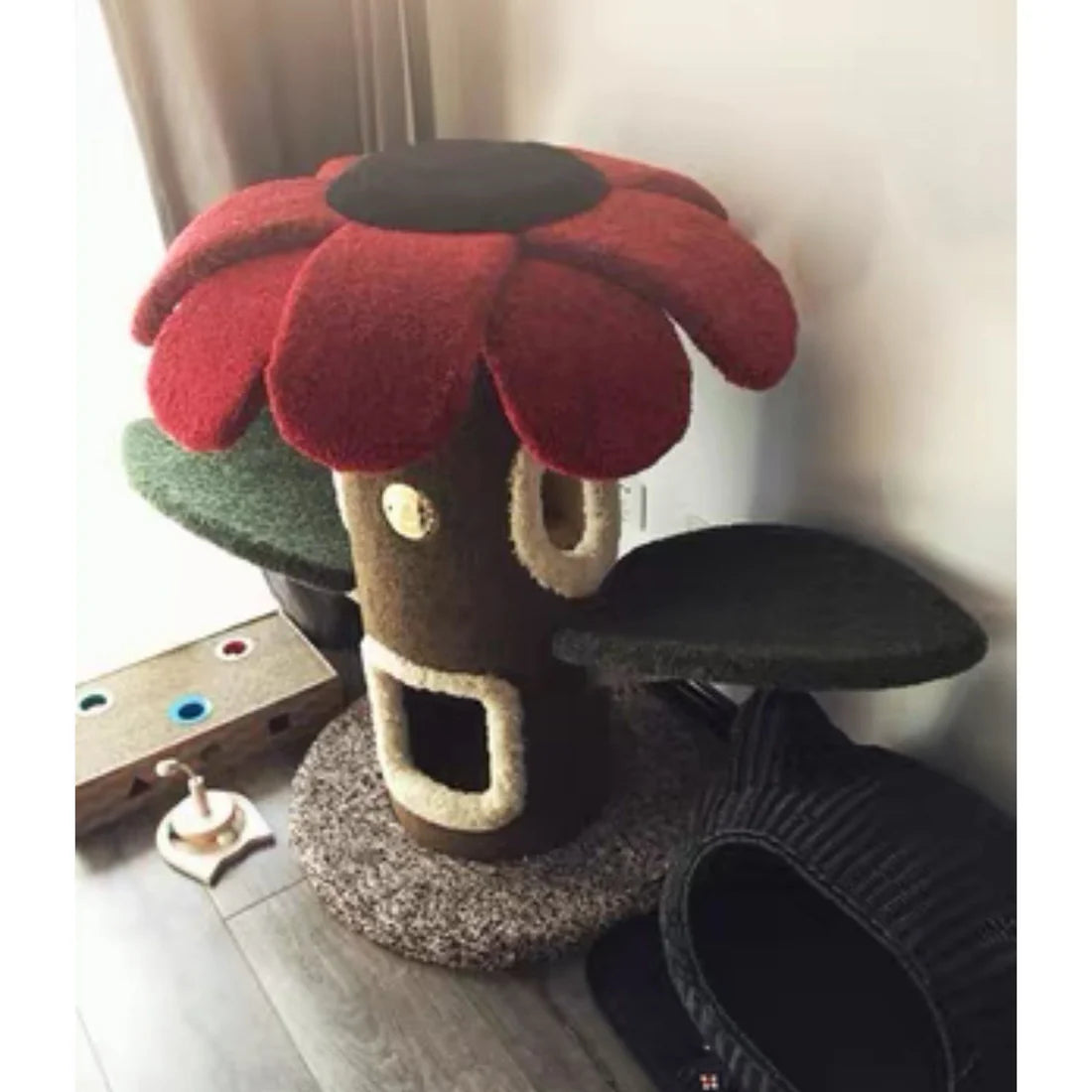 The deep red variant of the Camily Sunflower Cat Tree placed in a cozy living room corner, showcasing its vibrant aesthetic as a functional piece of modern pet furniture.
