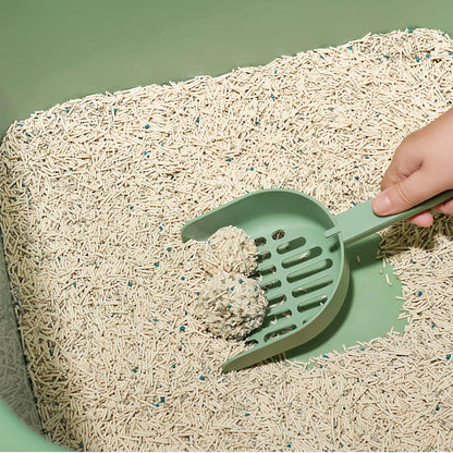 A hand using a green scoop to effortlessly remove two rock-hard clumps from the Michu Mixed Tofu Cat Litter Lite, ensuring a hassle-free, mess-free daily clean-up routine.