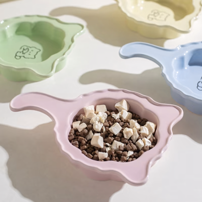 The Soft Pink Crooked Tail cat plate filled with kibble and freeze-dried treats, highlighting its 250ml capacity and shallow, whisker-friendly floral design.