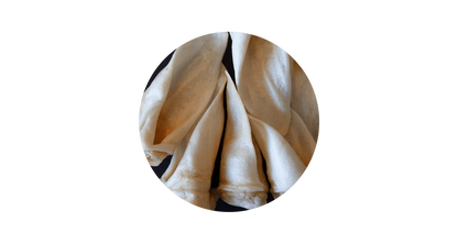 Close-up circular view of 100% pure air-dried lamb ear chews for dogs, highlighting the hard, crunchy texture designed to scrape away plaque and support dental health.