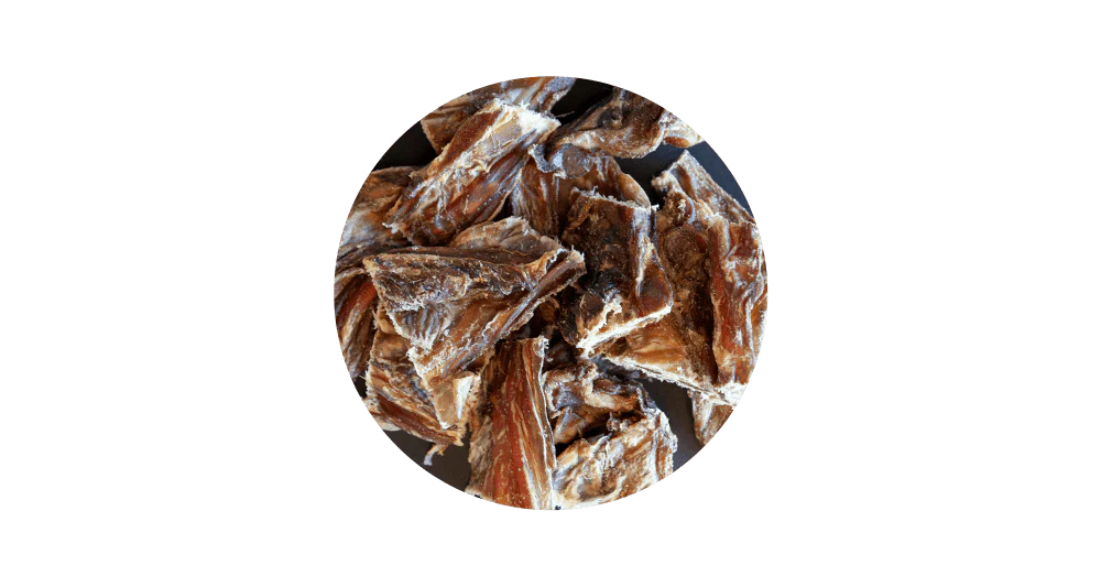 Close-up circular view of 100% pure air-dried veal brisket for dogs, highlighting its chewy, fibrous meaty texture designed to support dental health and naturally scrape away plaque.