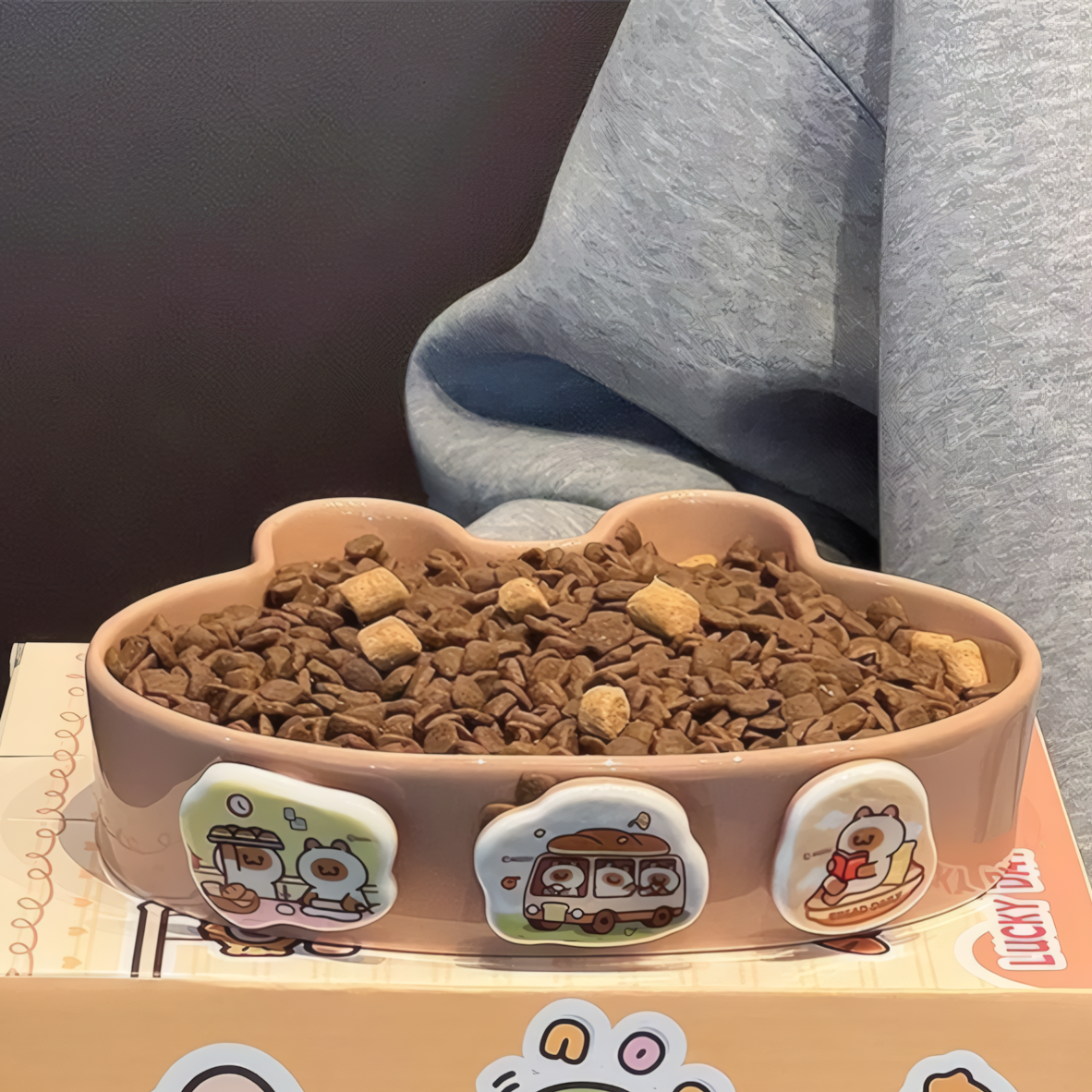 slow pet feeder filled with food on a box