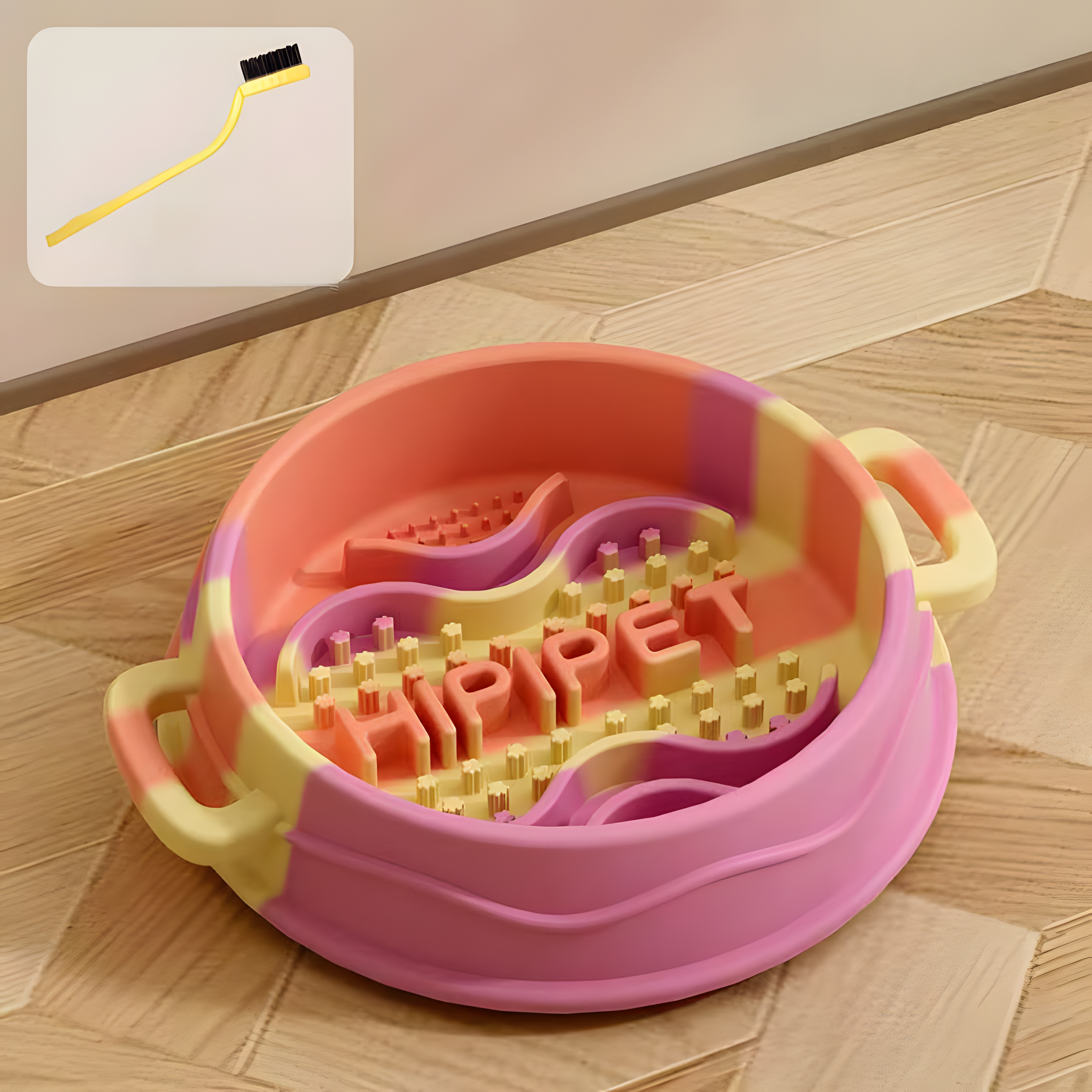 A Sunny Orange pastel swirl silicone slow feeder bowl on a wooden floor, featuring an inset graphic of the complimentary cleaning brush used to wash the deep maze dividers.