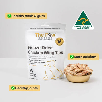 The Paw Grocer Freeze-Dried Chicken Wing Tips 90g bag with a bowl of treats. Highlights healthy teeth and gums, more calcium for strong bones, and healthy joint support. Australian made and owned.