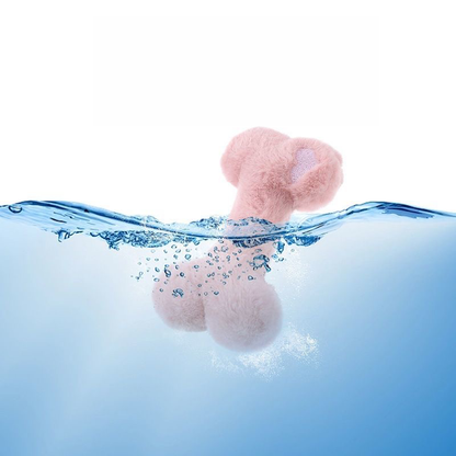 A pink plush bone dog toy partially submerged in clear, splashing blue water, demonstrating that the premium fabric and internal squeaker are fully washable and easy to clean.