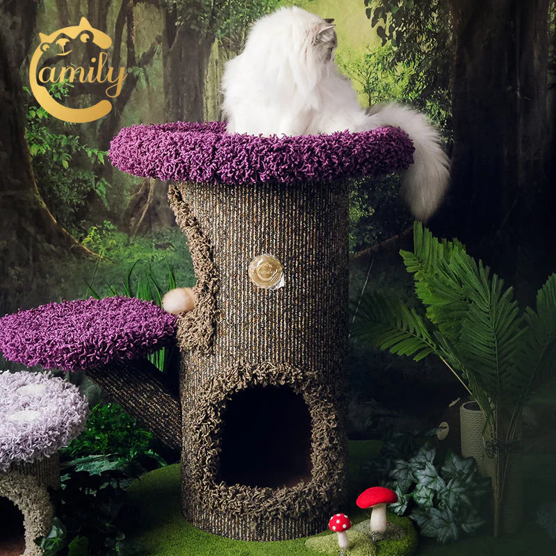 A beautiful white cat sitting on the dark purple penthouse platform of the Camily Mushroom Cat Tree, surrounded by an enchanted forest backdrop and interactive felt mushroom toys.