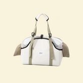 Full studio view of the white and olive green pet carrier tote, highlighting the anti-sag solid base and comfortable side resting pillows for cats and small dogs.