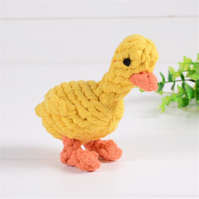 A side view of a charming yellow braided rope duck pet toy with an orange beak and feet, featuring a high-density knotted cotton texture for durable chewing.