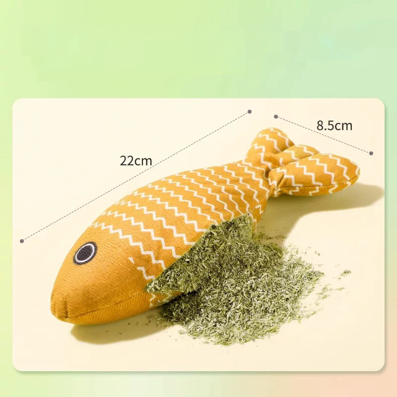 A 22cm yellow linen cat fish toy with a section cut open to reveal a generous filling of 100 percent natural catnip, designed as a soothing kicker toy to relieve feline stress.
