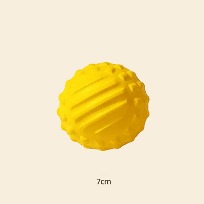 A clean montage view of the bright yellow solid core dog fetch ball against a white background, displaying its intelligent textured surface with ridges and bumps designed for easy grip and gentle gum massage.