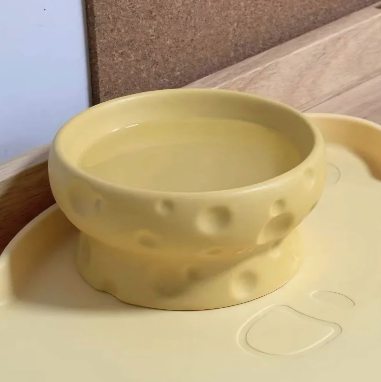 Yellow cheese bowl with a neutral background